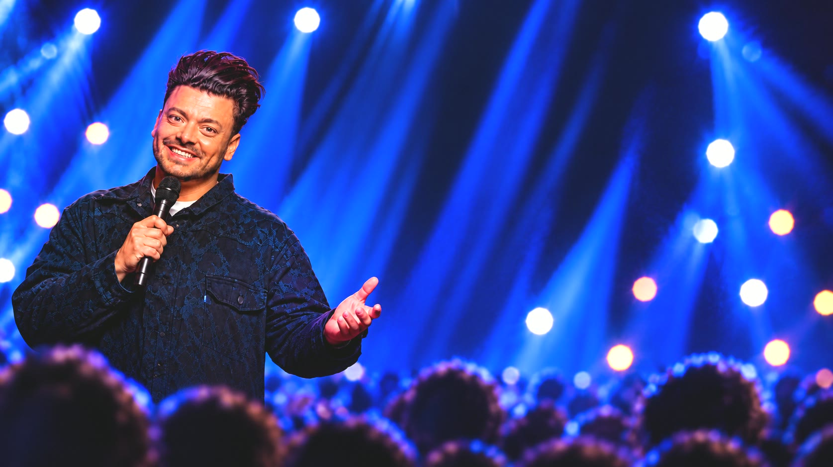 Kev Adams performing live on stage